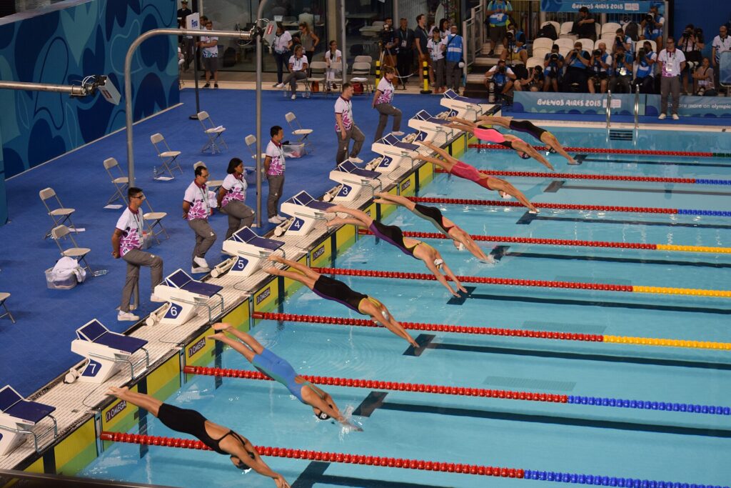 50 metrelik olimpik havuzda serbest stil finalinde yüzücülerin bloklardan suya atlayışı